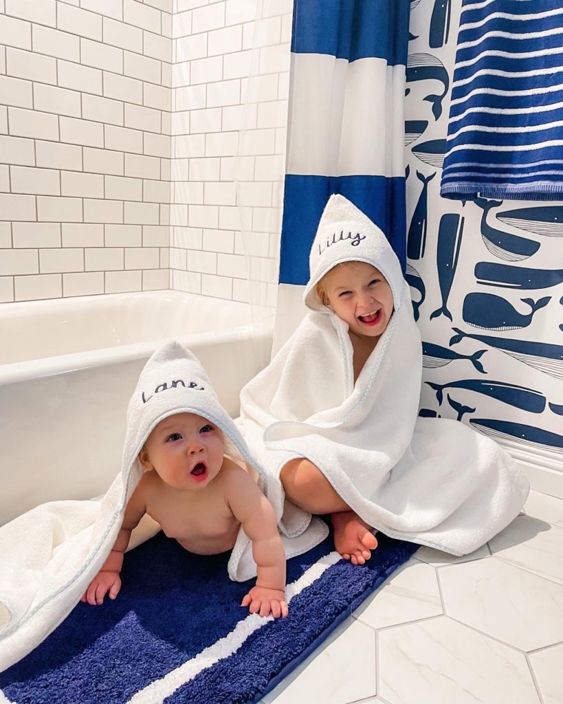 Kids Bathroom Renovation | Nautical Bathroom | Preppy Bathroom | Navy and White Bathroom | Navy Vanity | Serena and Lily Wallpaper | Pottery Barn Kids | Hexagon Tile | Shower Niche | Border Tile | Bathroom Remodel | Classic Bathroom | Brushed Gold Hardware