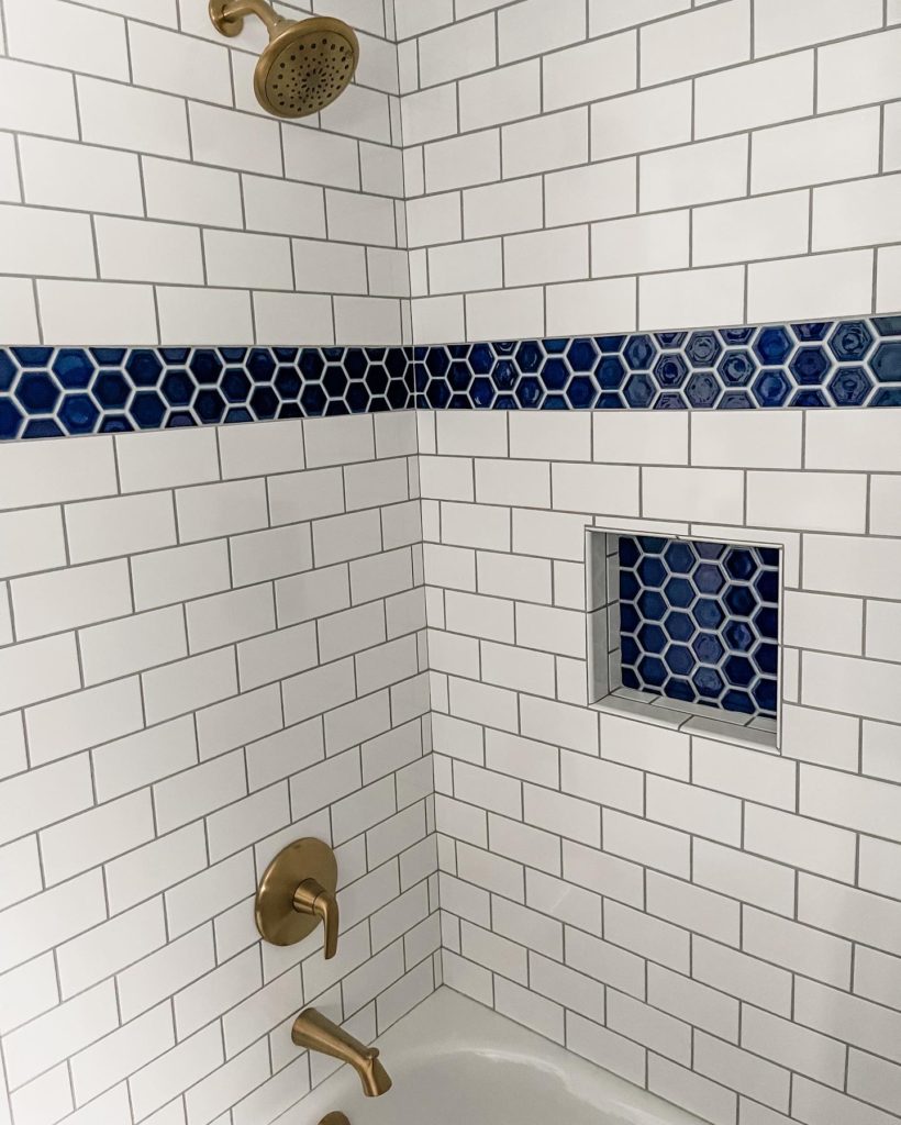 Kids Bathroom Renovation | Nautical Bathroom | Preppy Bathroom | Navy and White Bathroom | Navy Vanity | Serena and Lily Wallpaper | Pottery Barn Kids | Hexagon Tile | Shower Niche | Border Tile | Bathroom Remodel | Classic Bathroom | Brushed Gold Hardware